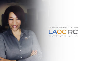 LAOCRC Executive Director Alex Davis standing next to LAOCRC logo