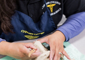Cypress College Mortuary science student working on clay mask
