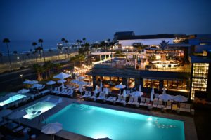 Panoramic view of Paséa Hotel & Resort swimming pool area overlooking the Pacific Ocean in Huntington Beach, Orange County, California USA.